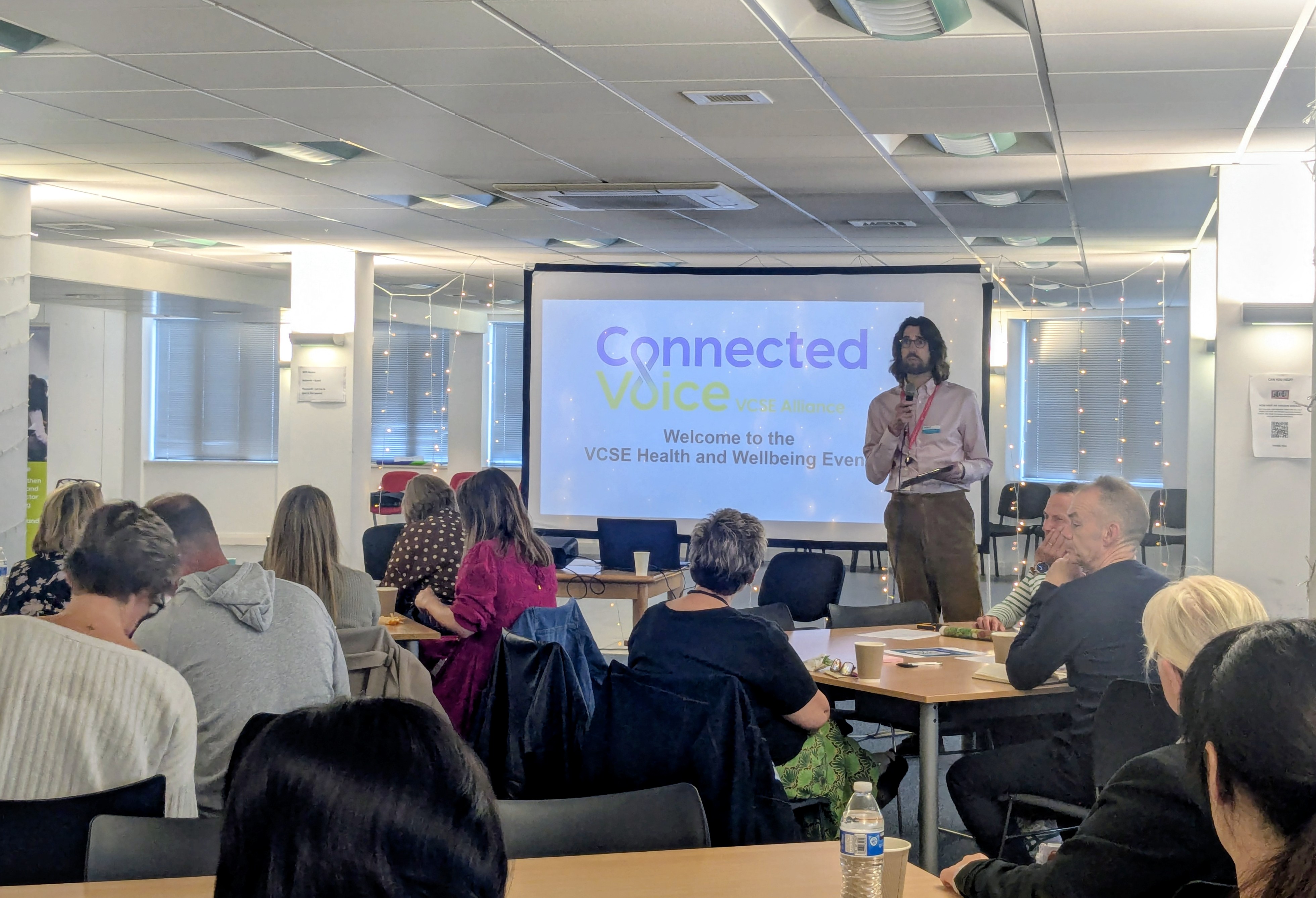 A speaker presenting the networking event to a room of attendees