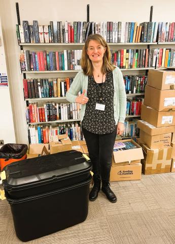 Member of staff at with a full box of collected devices