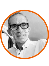 A black and white headshot of Alexandros Dearges-Chantler, he is wearing a white shirt and black glasses
